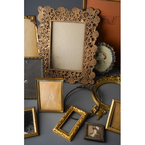 506 - Assorted early 20th Century gilt metal photograph frames, various sizes and designs (1 box)