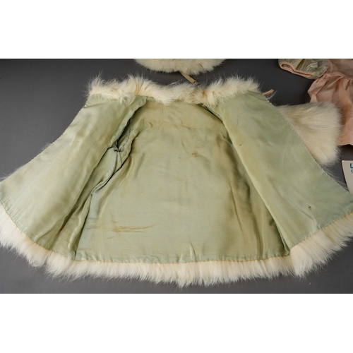 510 - Vintage doll's clothes to include: a white rabbit fur swing matinee coat with matching beret; a Macy... 