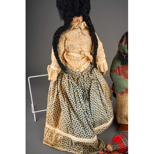 514 - An American Folk Art cloth Native Indian doll with painted face, she wear plaits, a blouse, skirt an... 