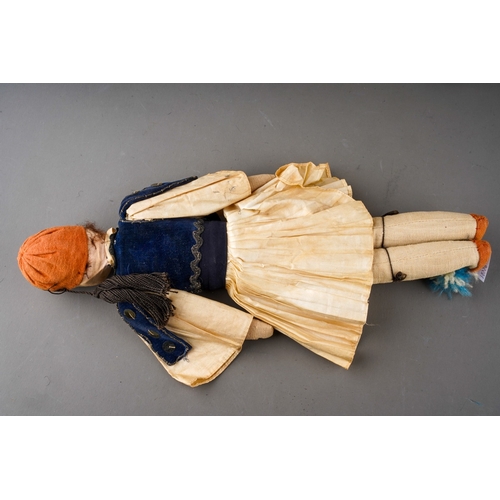 514 - An American Folk Art cloth Native Indian doll with painted face, she wear plaits, a blouse, skirt an... 