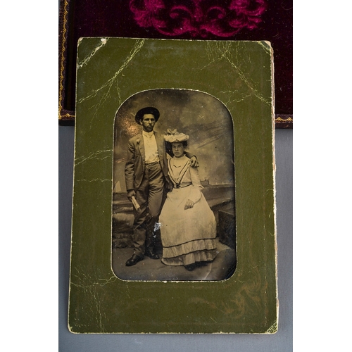 532 - A late 19th Century black and white family portrait group, the glazed and gilt frame within leather ... 