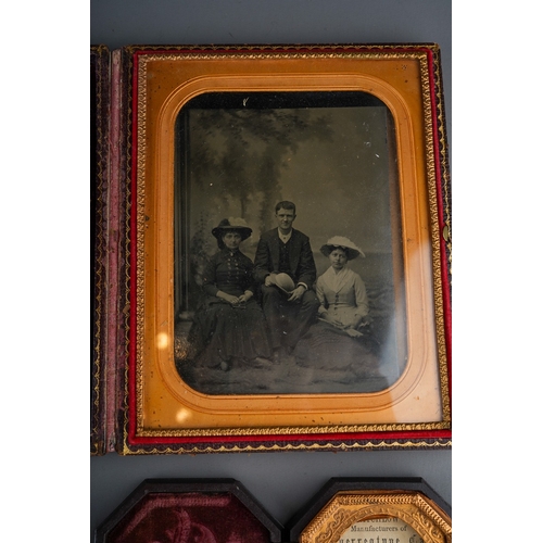 532 - A late 19th Century black and white family portrait group, the glazed and gilt frame within leather ... 