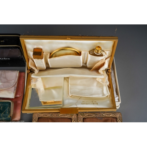 533 - A vintage Elizabeth Arden gilt metal mounted clutch purse make up bag, with box (damaged) together w... 