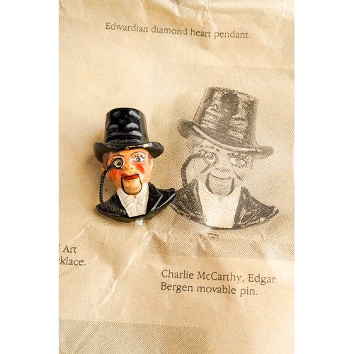 538 - An early 20th Century Charlie McCarthy mechanical painted pin brooch, after Edgar Bergen`s ventriloq... 