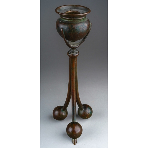 549 - An early 20th Century American Tiffany Studios pattern no 2102 cast bronze candlestick with urn shap... 