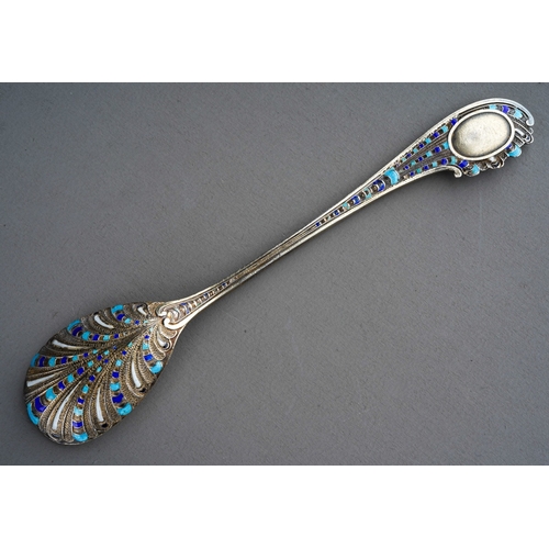 553 - A late 19th Century American silver gilt and enamel coffee spoon, engraving to bowl dated (18)95., m... 