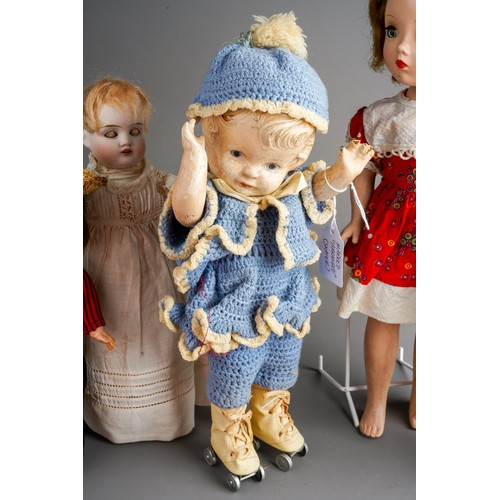 558 - A collection of vintage dolls to include: a Georgian style peg doll with painted face, wool hair, ye... 