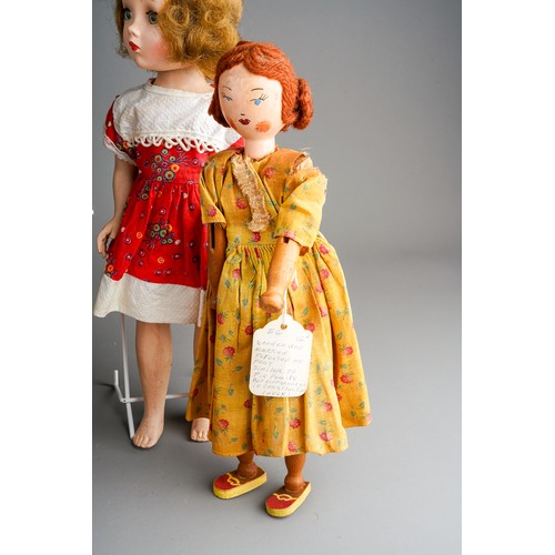 558 - A collection of vintage dolls to include: a Georgian style peg doll with painted face, wool hair, ye... 