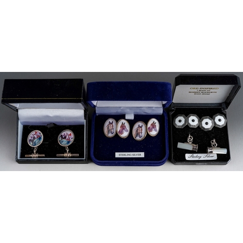 579 - Four pairs of cufflinks, comprising a pair in the form of shotgun cartridges in silver and mother of... 