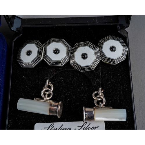 579 - Four pairs of cufflinks, comprising a pair in the form of shotgun cartridges in silver and mother of... 