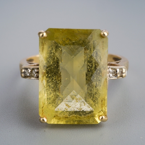 583 - A 9ct gold citrine and diamond dress ring. Set with a principal top faceted rectangular shape citrin... 