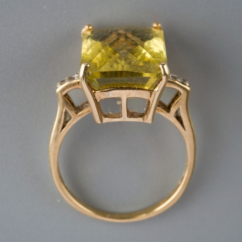 583 - A 9ct gold citrine and diamond dress ring. Set with a principal top faceted rectangular shape citrin... 