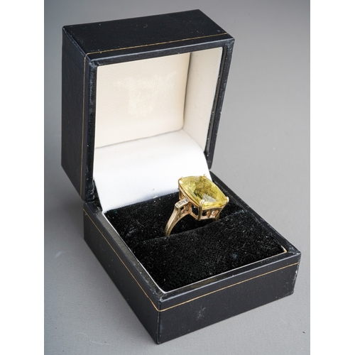 583 - A 9ct gold citrine and diamond dress ring. Set with a principal top faceted rectangular shape citrin... 