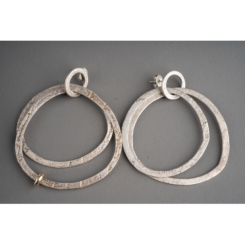 592 - A Diana Porter silver earrings and a bangle. The hallmarked silver by the Bristol jewellery designer... 