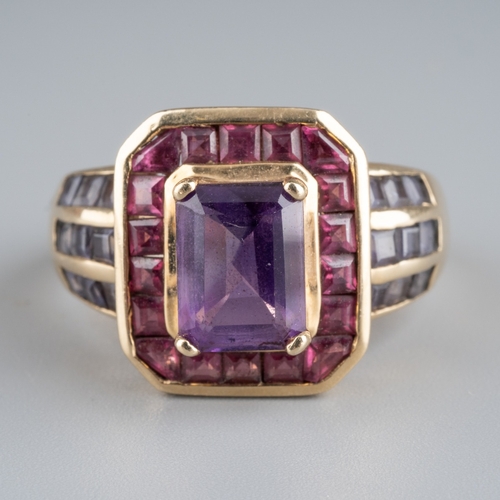 607 - A 9ct gold gem set dress ring. Set with a central amethyst, surrounded by pink gemstones and purple ... 