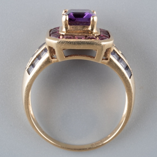 607 - A 9ct gold gem set dress ring. Set with a central amethyst, surrounded by pink gemstones and purple ... 