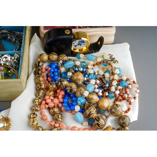 611 - A collection of costume jewellery in two jewellery boxes and a bag, including bead necklaces, a hear... 