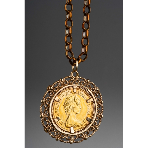 616 - A 1982 half sovereign mounted within a 9ct gold filigree pendant mount with four illusion set white ... 