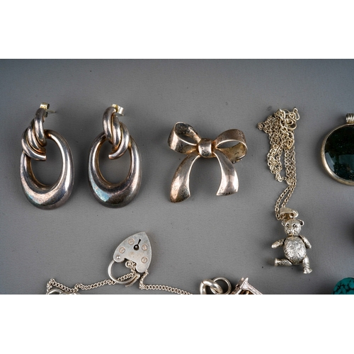 643 - Collection of silver and white metal jewellery to include charm bracelets, agate pendants, brooch, r... 