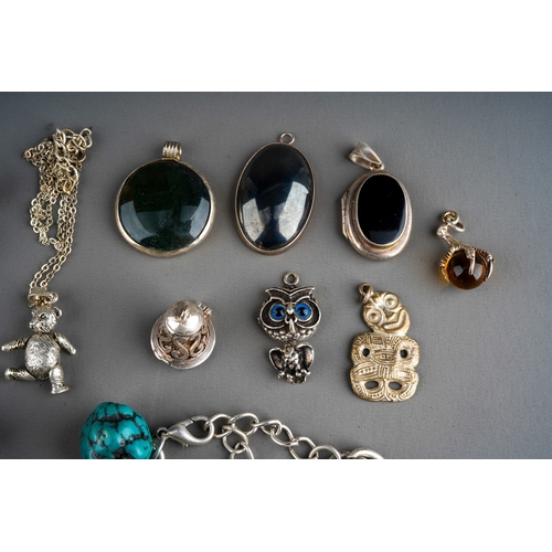 643 - Collection of silver and white metal jewellery to include charm bracelets, agate pendants, brooch, r... 