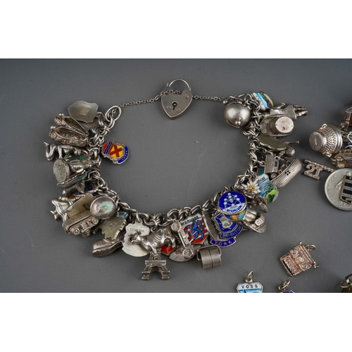 658 - Collection of silver charms on 3 bracelet with enamelled and various other charms. Gross weight 201g