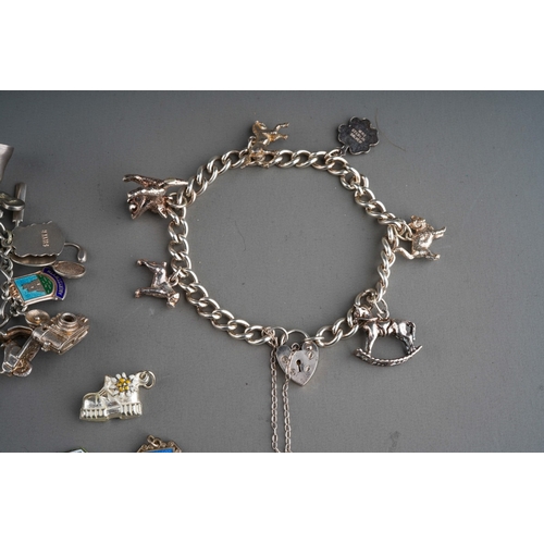 658 - Collection of silver charms on 3 bracelet with enamelled and various other charms. Gross weight 201g