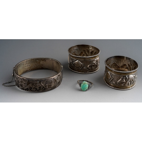 661 - A pair of Indian white metal napkin rings embossed with an elephant and mountains together with a 92... 