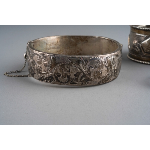 661 - A pair of Indian white metal napkin rings embossed with an elephant and mountains together with a 92... 