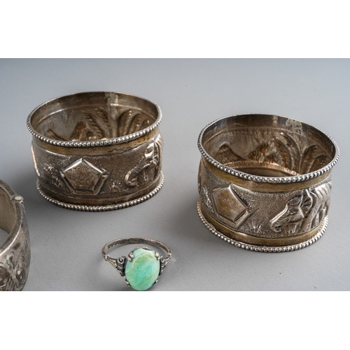 661 - A pair of Indian white metal napkin rings embossed with an elephant and mountains together with a 92... 