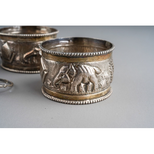 661 - A pair of Indian white metal napkin rings embossed with an elephant and mountains together with a 92... 