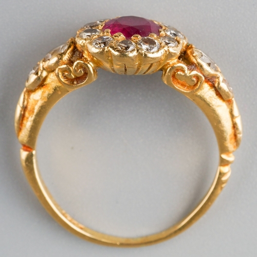 663 - A modern ruby and diamond cluster ring. Set with a central ruby, surrounded by round brilliant cut d... 