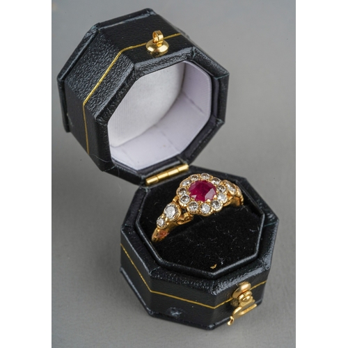 663 - A modern ruby and diamond cluster ring. Set with a central ruby, surrounded by round brilliant cut d... 