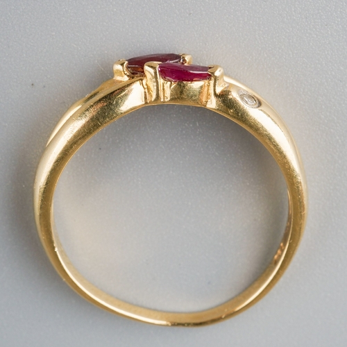 664 - A ruby and diamond dress ring. Set with two marquise shape rubies and two round brilliant cut diamon... 