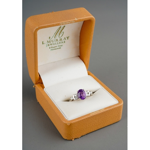 666 - A 9ct white gold amethyst and diamond dress ring. Set with a central oval shape amethyst, with round... 