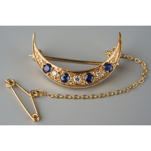 667 - A 9ct gold sapphire and diamond crescent brooch. Set with graduating round brilliant cut diamonds an... 