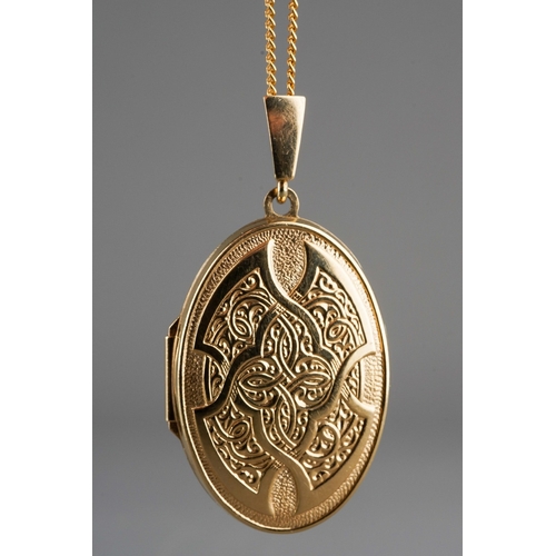 672 - A 9ct gold locket with chain. The oval locket with scroll embossed front, suspended from a flat curb... 