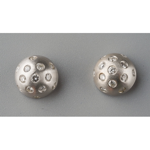 673 - A pair of 18ct white gold diamond earrings. Each ear stud set with thirteen round brilliant cut diam... 