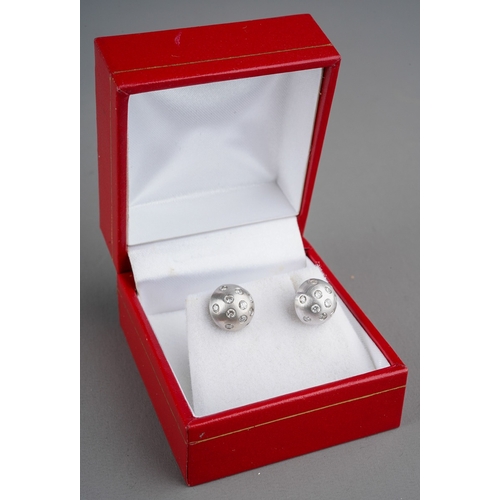 673 - A pair of 18ct white gold diamond earrings. Each ear stud set with thirteen round brilliant cut diam... 