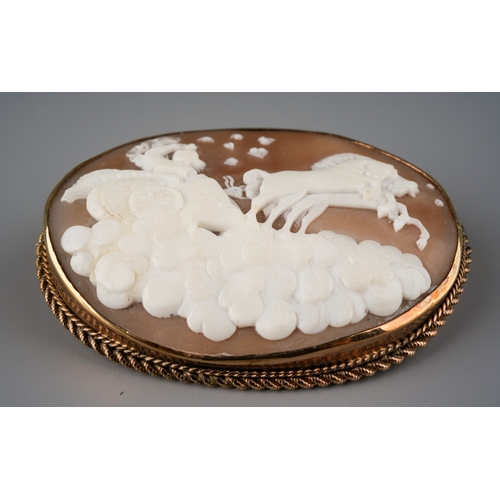 675 - A large shell cameo brooch. The oval shell cameo within a rope twist border, stamped 9ct, diameter o... 