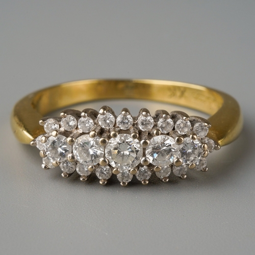 676 - An 18ct gold diamond dress ring. Set with five graduating round brilliant cut diamonds, within a rou... 