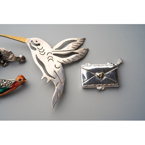 695 - Three novelty silver white metal brooches and a novelty pendant, including an enamel and marcasite p... 