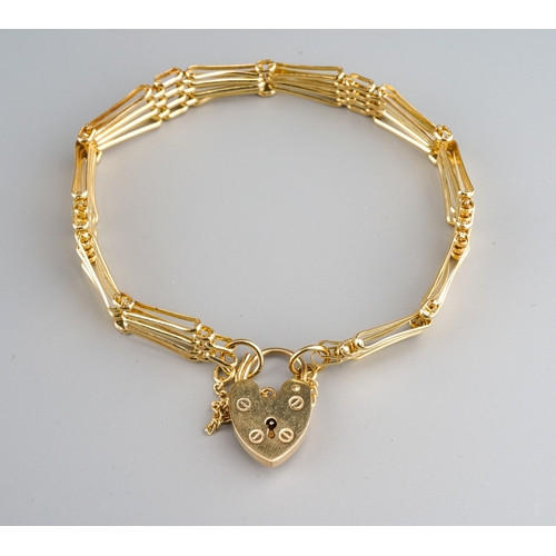 713 - A 9ct gold gate bracelet. The four row gate bracelet with padlock clasp, approx length of bracelet 1... 