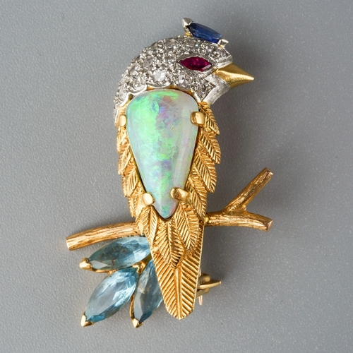 714 - E WOLFE & CO an 18ct gold diamond and gem set novelty brooch. Designed as an exotic bird, with a pea... 