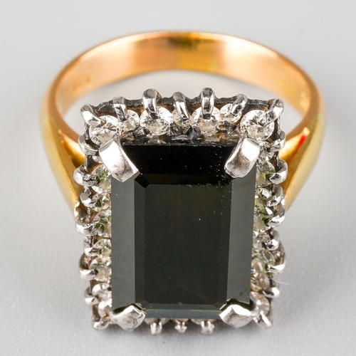 716 - A tourmaline and diamond cluster ring. Set with a rectangular tourmaline, measuring approx 13.31 - 8... 