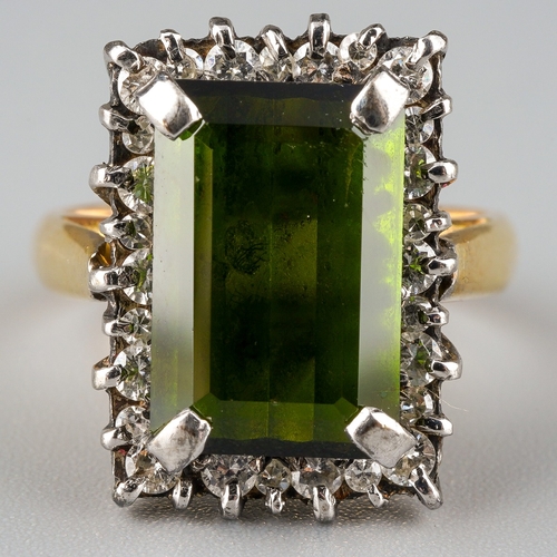 716 - A tourmaline and diamond cluster ring. Set with a rectangular tourmaline, measuring approx 13.31 - 8... 