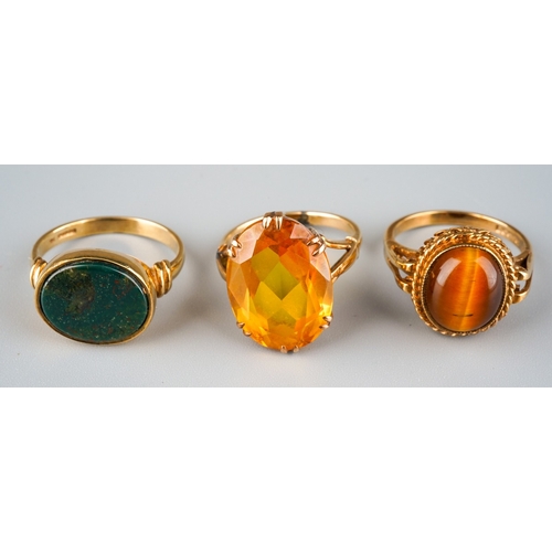 718 - Three gem set rings. To include a yellow synthetic sapphire single stone ring, stamped 9ct, together... 