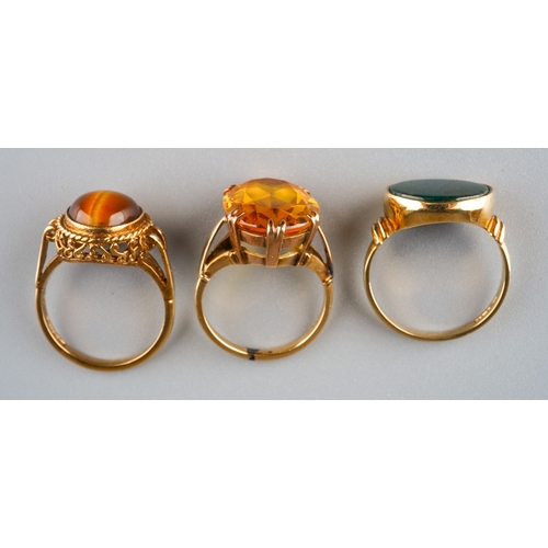 718 - Three gem set rings. To include a yellow synthetic sapphire single stone ring, stamped 9ct, together... 