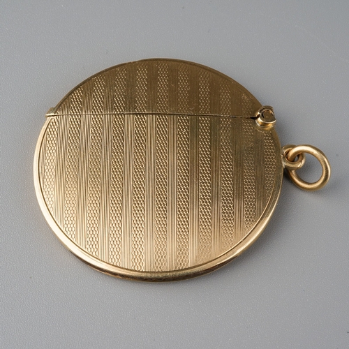 727 - An Edwardian 9ct gold engine turned circular vesta case, with central vacant cartouche, on suspensio... 