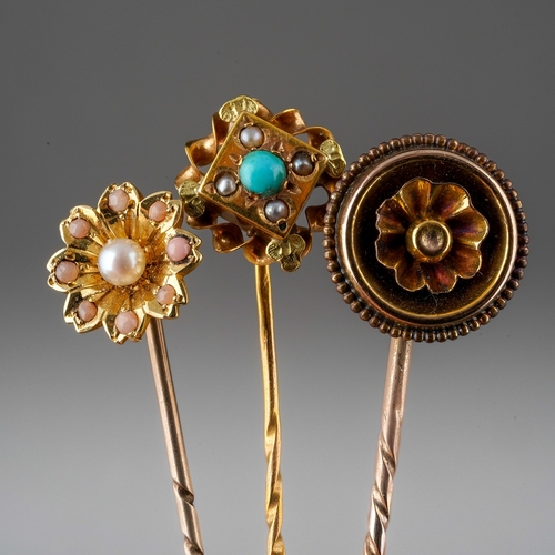 733 - A collection of four stickpin. To include a cultured pearl and pink cabochon floral stickpin, a synt... 