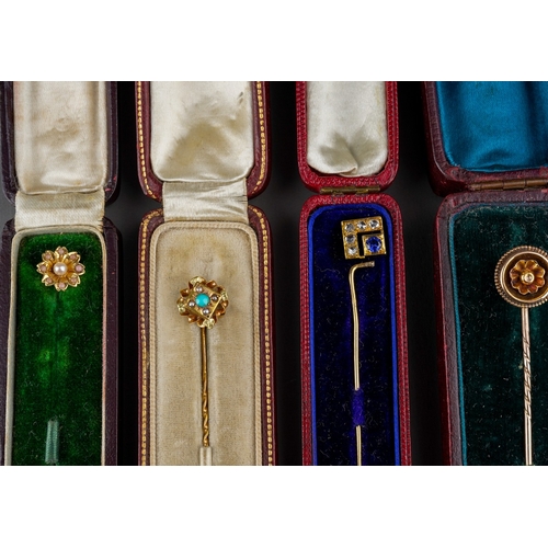 733 - A collection of four stickpin. To include a cultured pearl and pink cabochon floral stickpin, a synt... 